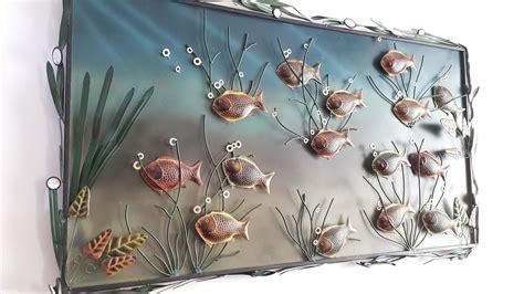 there are many sea animals on this glass wall art piece that is hanging ...