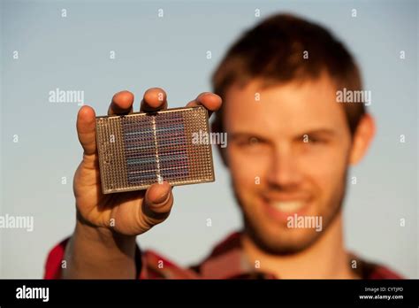 Handsome young man with small solar panel in hand Stock Photo - Alamy