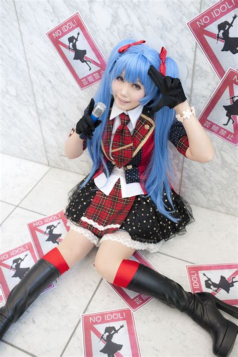 a woman with blue hair and black boots sitting on the floor in front of ...