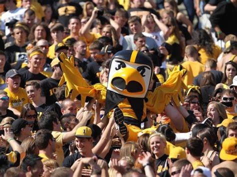 Tales of a College Sports-a-holic • Iowa Hawkeye mascot Herkey The Hawk is carried up...