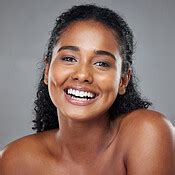 Black woman, beauty and smile with teeth for skincare, makeup or cosmetics against a grey studio ...