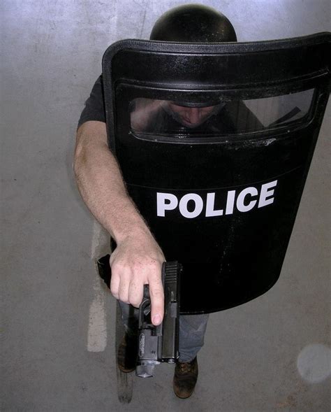 Police officer with ballistic shield. | Police, Shield, Swat