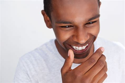 Premium Photo | Young guy laughing with hand covering mouth