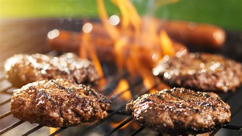 hamburgers and hotdogs cooking on flaming grill - RAF Association ...