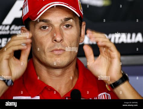 Italian Formula One driver Giancarlo Fisichella of Scuderia Ferrari gestures during a FIA press ...