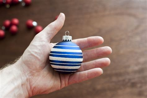 Photo of holding blue Christmas ball | Free christmas images