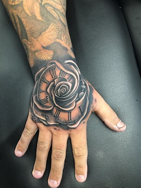 Rose hand tattoo by Greg at Holy Trinity Tattoos | Hand tattoos for guys, Rose hand tattoo, Hand ...