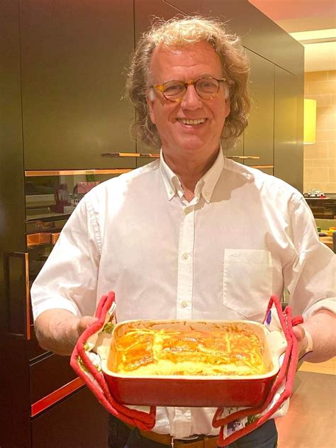 a man is holding a large casserole in his hands