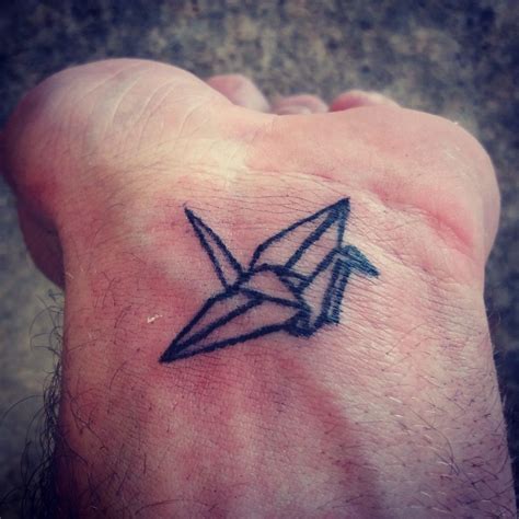 Origami crane tattoo on wrist. | Wrist tattoos, Origami tattoo, Paper crane tattoo