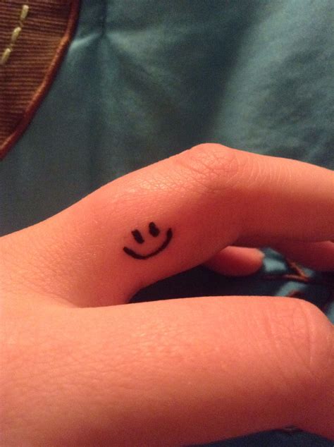 Smiley Face Finger Tattoo