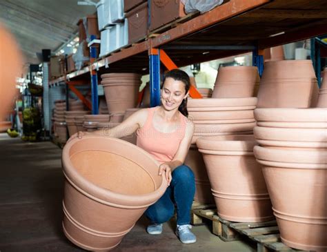 Young Woman Customer Choosing Big Clay Pot for Garden Stock Photo ...