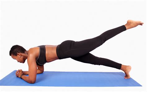 Strong woman doing plank with leg raised