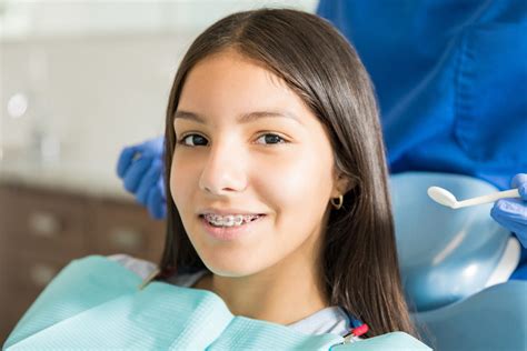 Portrait Of Smiling Teenage Girl With Braces In Clinic - Chicago KiDDS