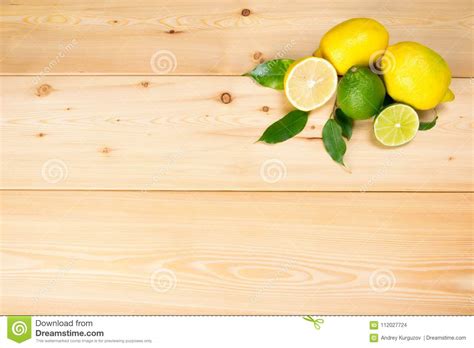 On Light Wooden Boards in the Corner a Pile of Lemons Stock Photo - Image of green, nutrition ...