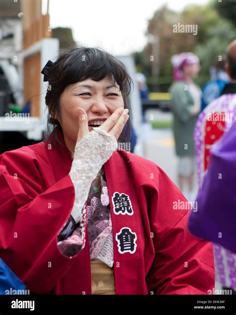 Japanese woman laughing with hand covering mouth Stock Photo - Alamy