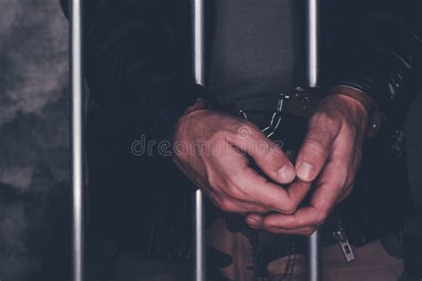 Handcuffed Man Behind Prison Bars Stock Photo - Image of imprison ...