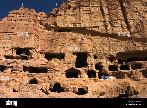 AFGHANISTAN Bamiyan Province Caves in cliffs near empty niche where the ...