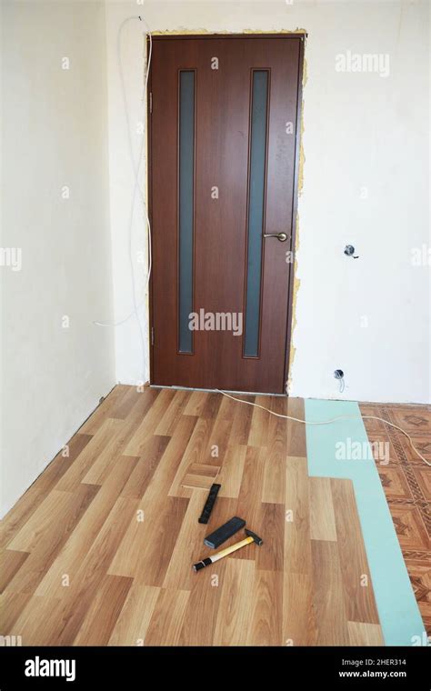 Laminate flooring installation interior. Installing wooden laminate flooring Stock Photo - Alamy