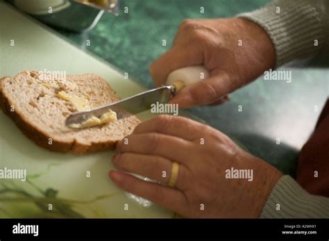 Stroke victim buttering bread Stock Photo - Alamy