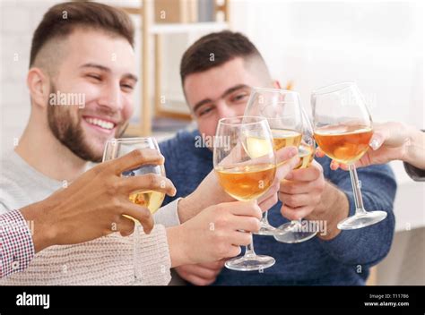 Celebrate meeting. Friends clinking wine glasses at home Stock Photo - Alamy
