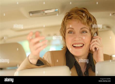 Businesswoman making a phone call in a car Stock Photo - Alamy
