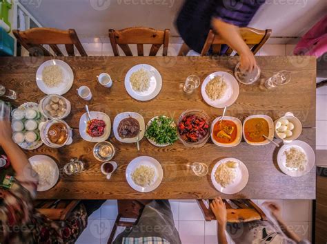 Setting up the table for family dinner 13354433 Stock Photo at Vecteezy