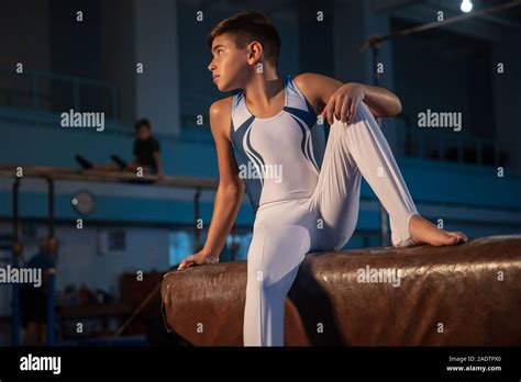 Little male gymnast training in gym, flexible and active. Caucasian fit little boy, athlete in ...