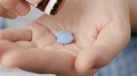 Two Big Blue Diamond-shaped Pills Labeled 100 Fall into Palm of Hand ...