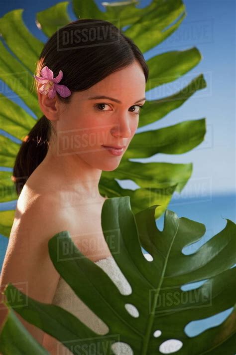 Portrait of woman among tropical plants - Stock Photo - Dissolve