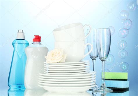 Empty clean plates, glasses and cups with dishwashing liquid and sponges on blue , #Ad, #plates ...