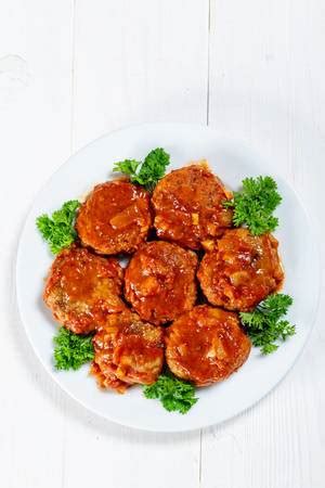 Homemade meat cutlets with Cutlery, herbs and tomatoes - Creative ...