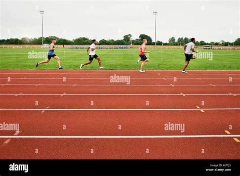 Runners training on running track Stock Photo - Alamy