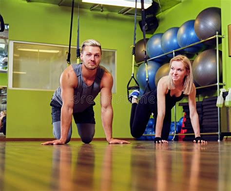 Sporty Male and Female Doing Trx Straps Exercises in a Gym Club. Stock ...