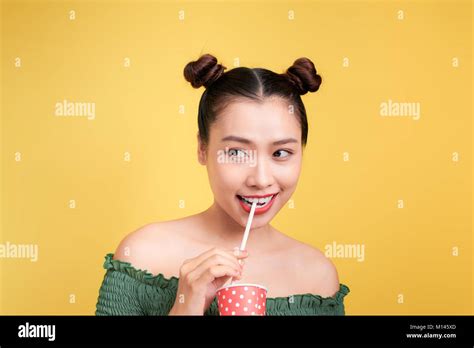 Beautiful crazy smiling asian woman girl with red lips drinking cola with straw Stock Photo - Alamy