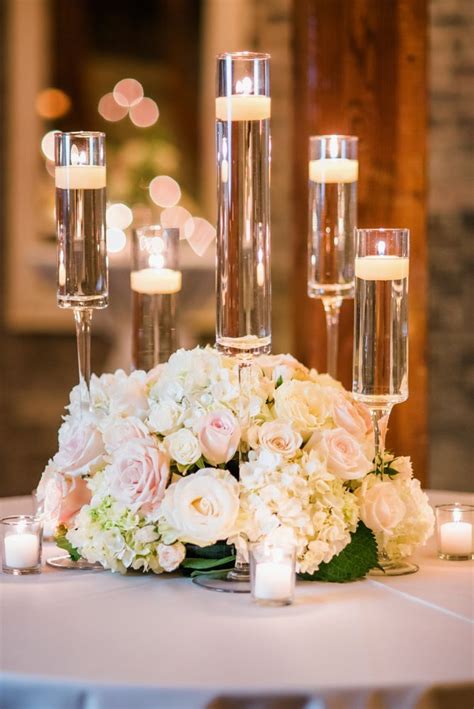 Low lush centerpiece; using ivory and blush roses with hydrangea and spray roses Hydrangea ...