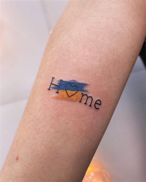 Tattoo of the word "home" and Ukraine's flag.