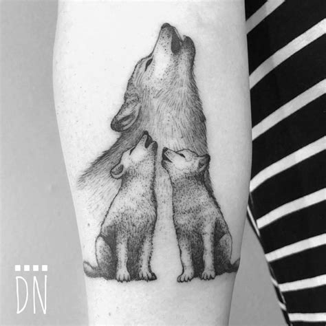 Wolf family tattoo on the inner forearm.