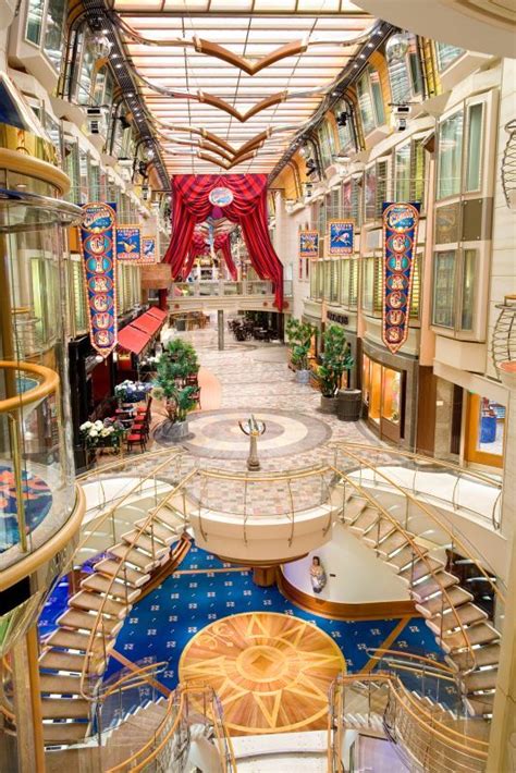 the inside of a cruise ship with many tables and chairs on each side of ...