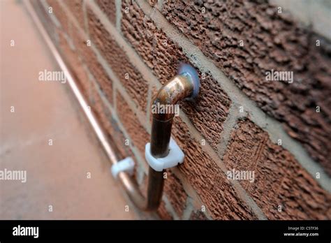 copper pipe carrying gas supply into property england uk Stock Photo - Alamy