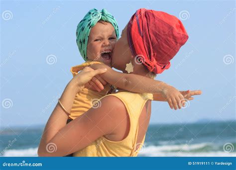 Young Mother Hugging Her Daughter on Beach Stock Image - Image of active, daughter: 51919111