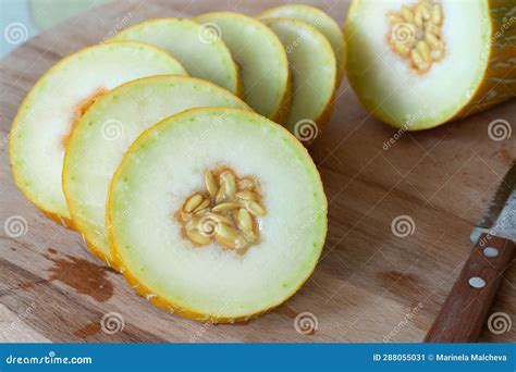 Sliced Persian Melon with Seeds on a Wooden Table with Knife Stock Image - Image of variety ...