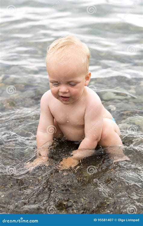 Happy Toddler Playing in the Sea. Cute Baby Boy Splashing in the Black ...