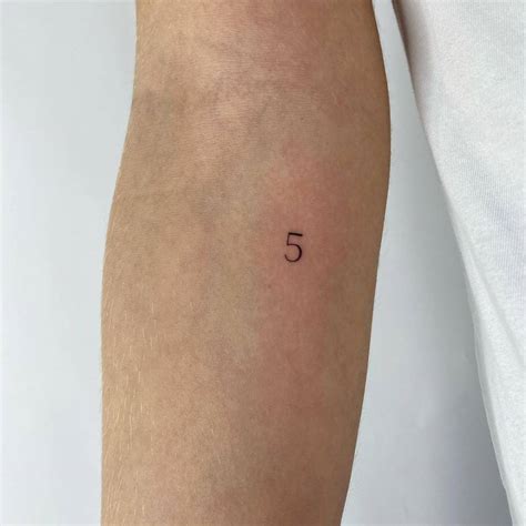 Number 5 tattooed on the inner forearm.