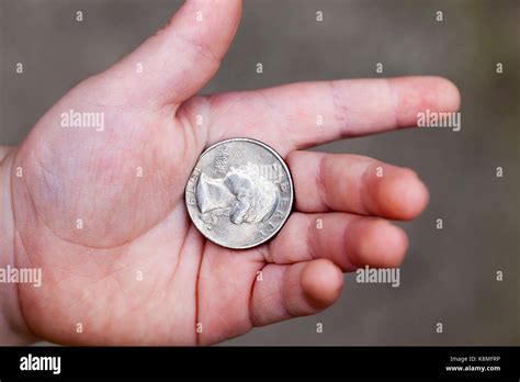 lying in the hand of the child's American coin in a quarter. Photo ...