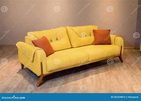 Closeup Shot of a Yellow Modern Couch on a Wooden Floor Stock Image ...