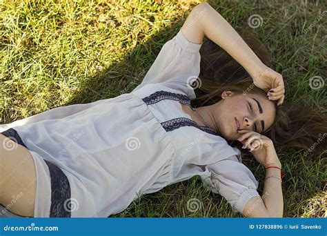 Beautiful Young Woman in White Dress Lying on Grass Stock Photo - Image of fresh, caucasian ...