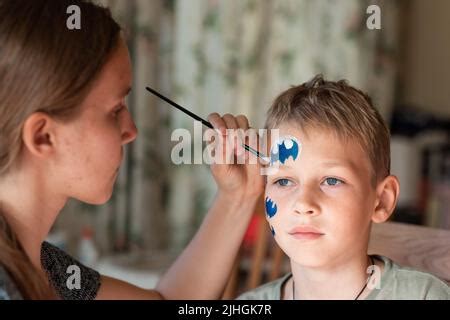 Young woman with a carnival mask making silence gesture Stock Photo - Alamy