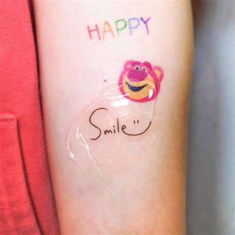 Tattoo of the word "smile" located on the inner