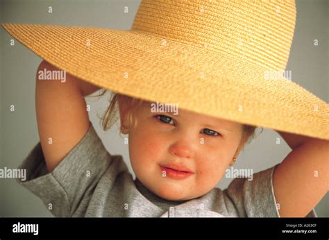 YOUNG GIRL WEARING SUN HAT Stock Photo - Alamy