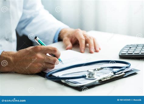 Doctor Writing Prescription at Desk in Clinics Office Stock Image ...